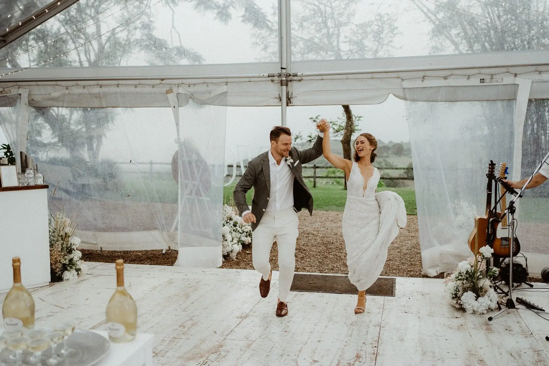 Breanna and Matt laughing together in the empty marquee, Byron View Farm