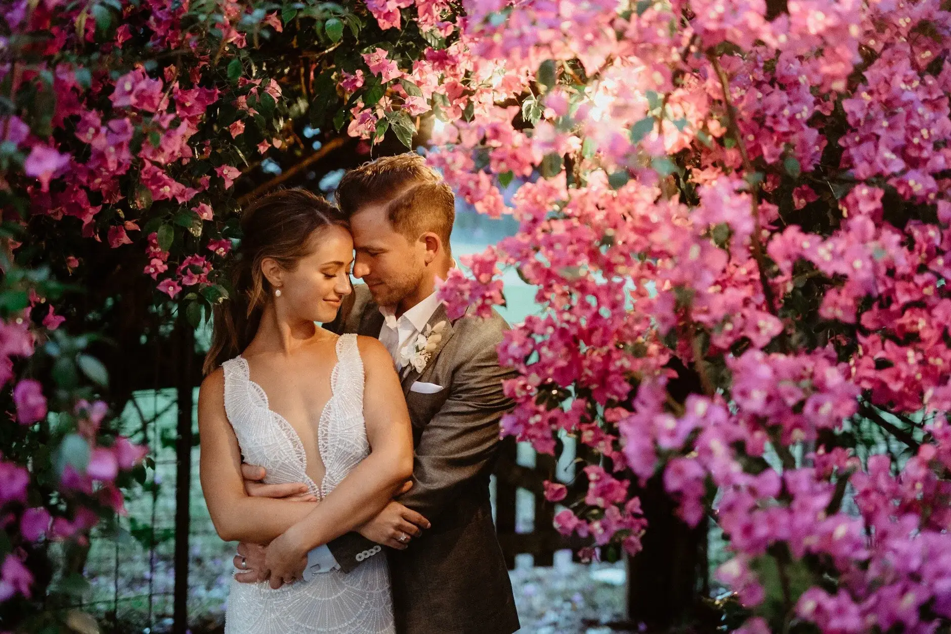 Breanna and Matt among bright bougainvillea, Byron View Farm