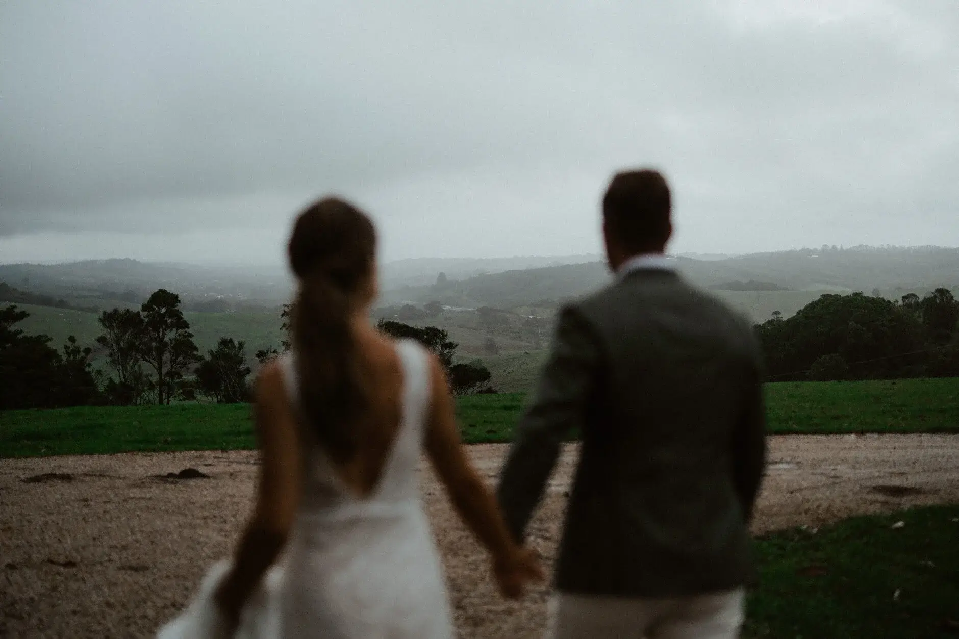 The couple looking out over the valley in the rain, Byron View Farm