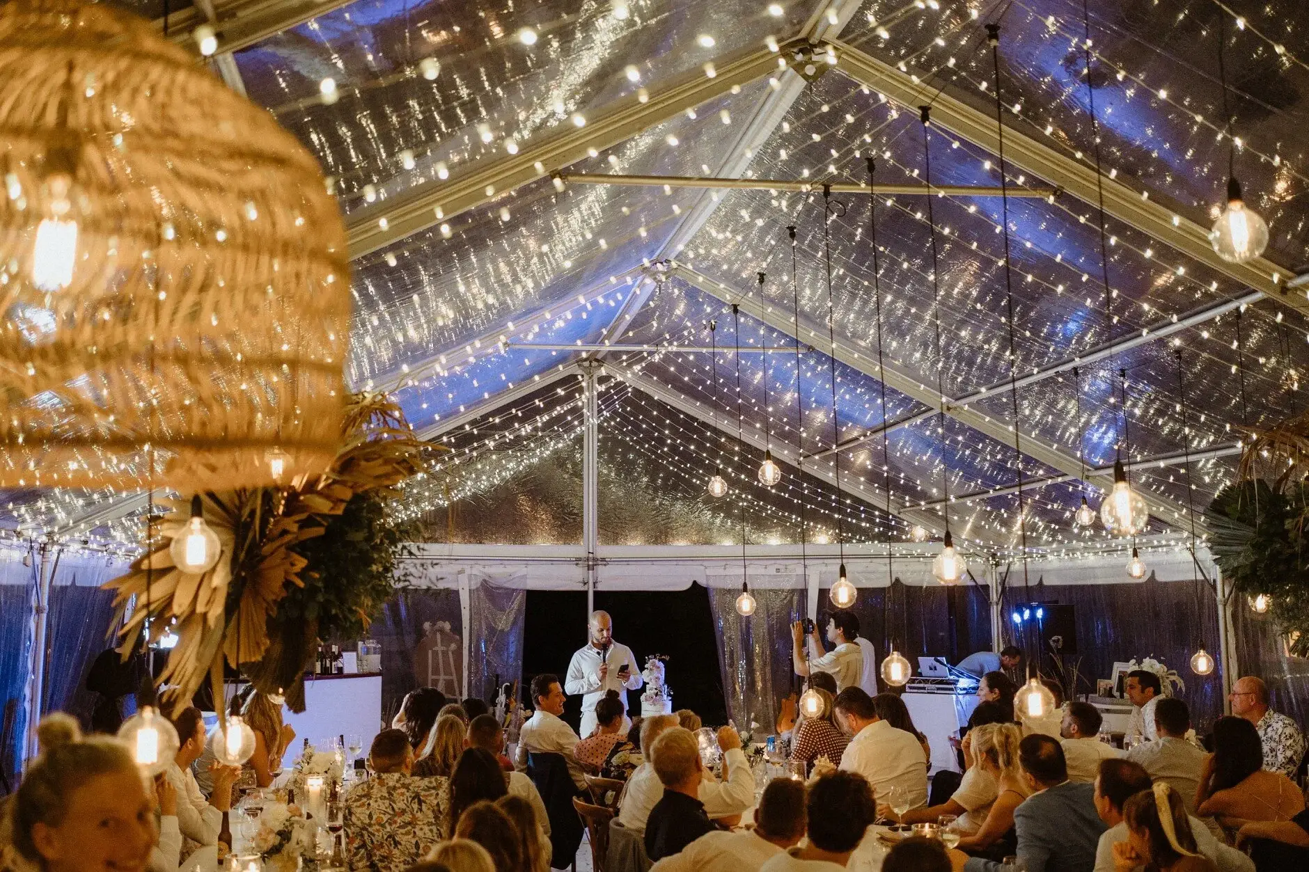 The marquee glowing with festoon lights during speeches, Byron View Farm