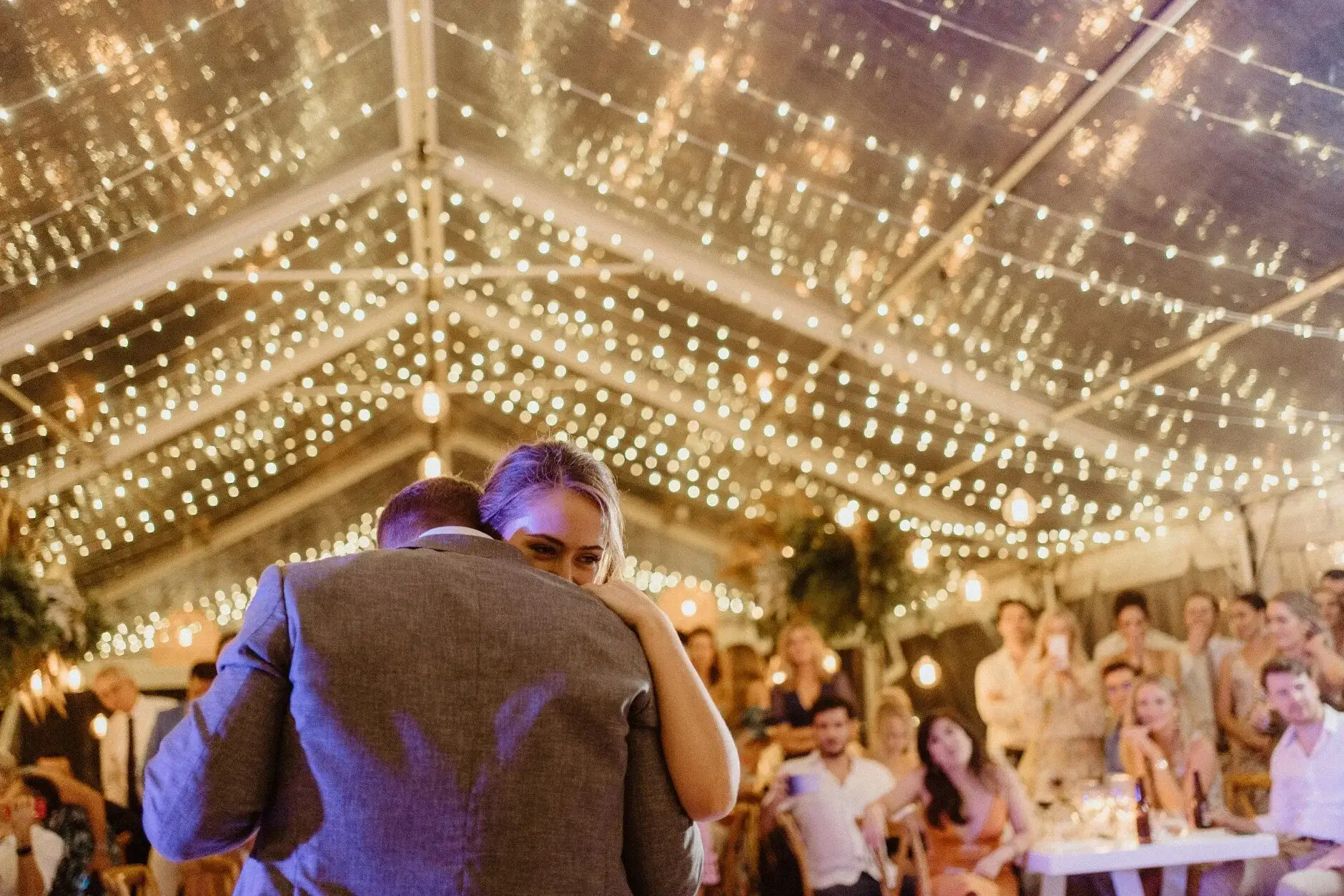 The couple dancing beneath the lit marquee roof, Byron View Farm