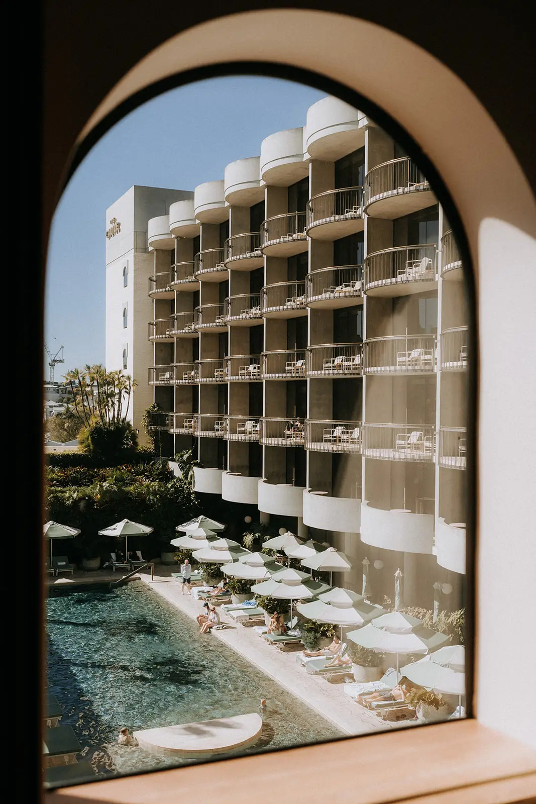 An arch on the guest floor looking down to the pool, The Calile Hotel