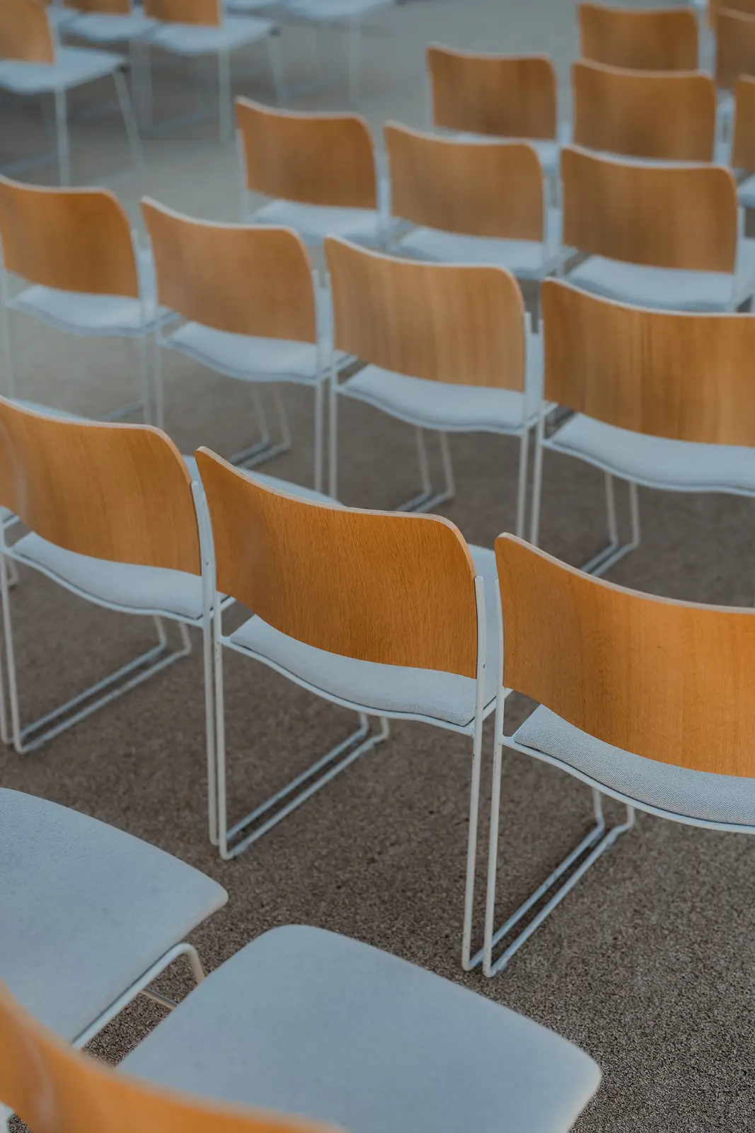 Rows of tan and white chairs set out for the ceremony, The Calile Hotel