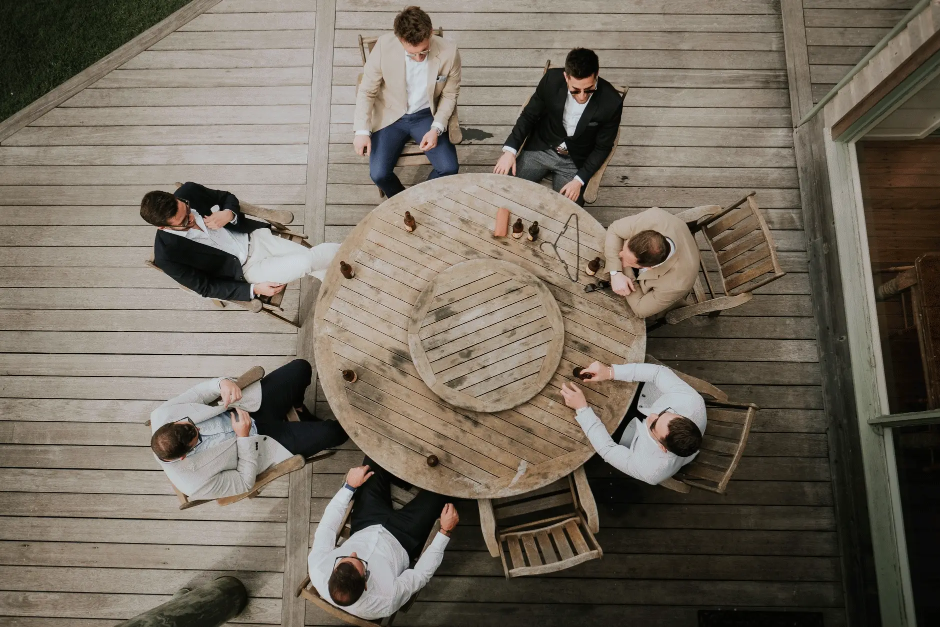 The groomsmen around the round table on the deck, seen from above
