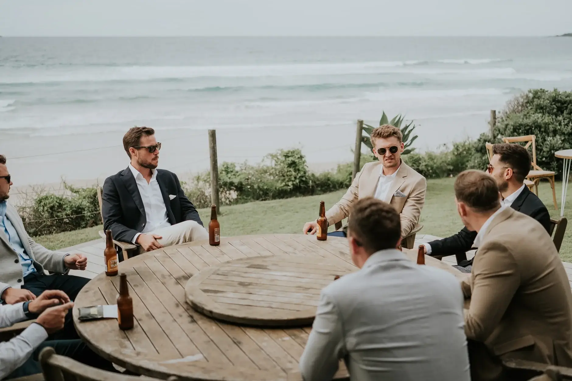 Jack and the boys sitting with beers by the dunes, Belongil Beach
