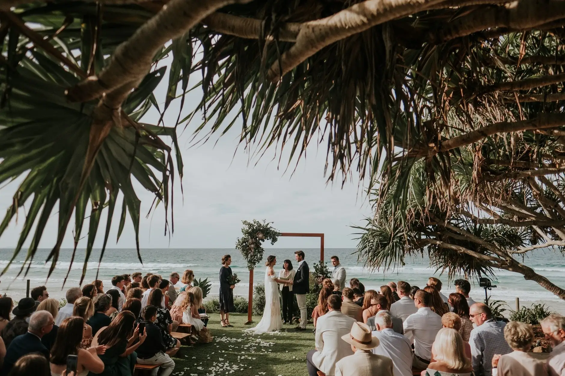 Cassie and Jack laughing as the ceremony begins, Belongil Beach