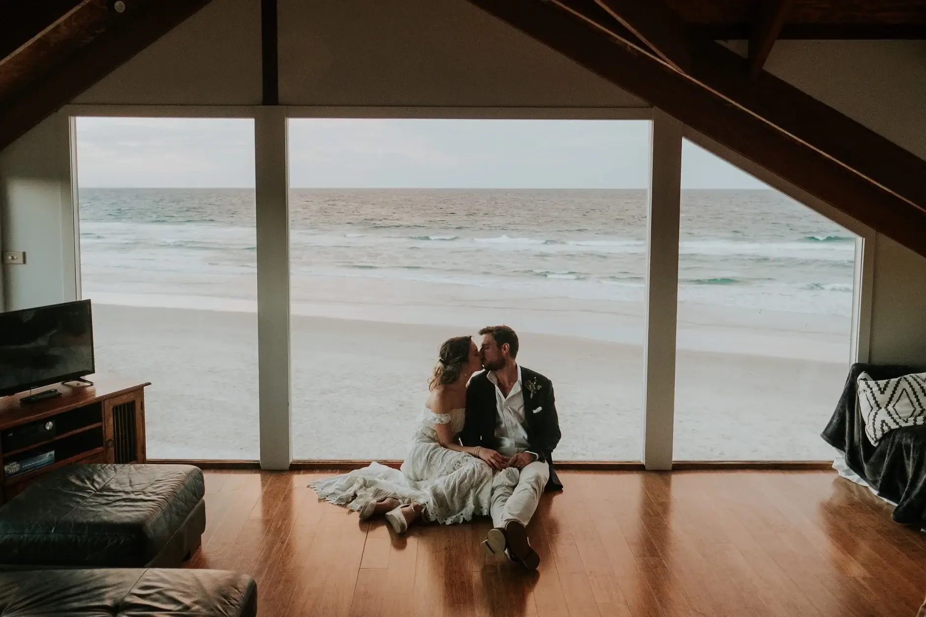Cassie and Jack on the floor by the glass wall, Belongil Beach