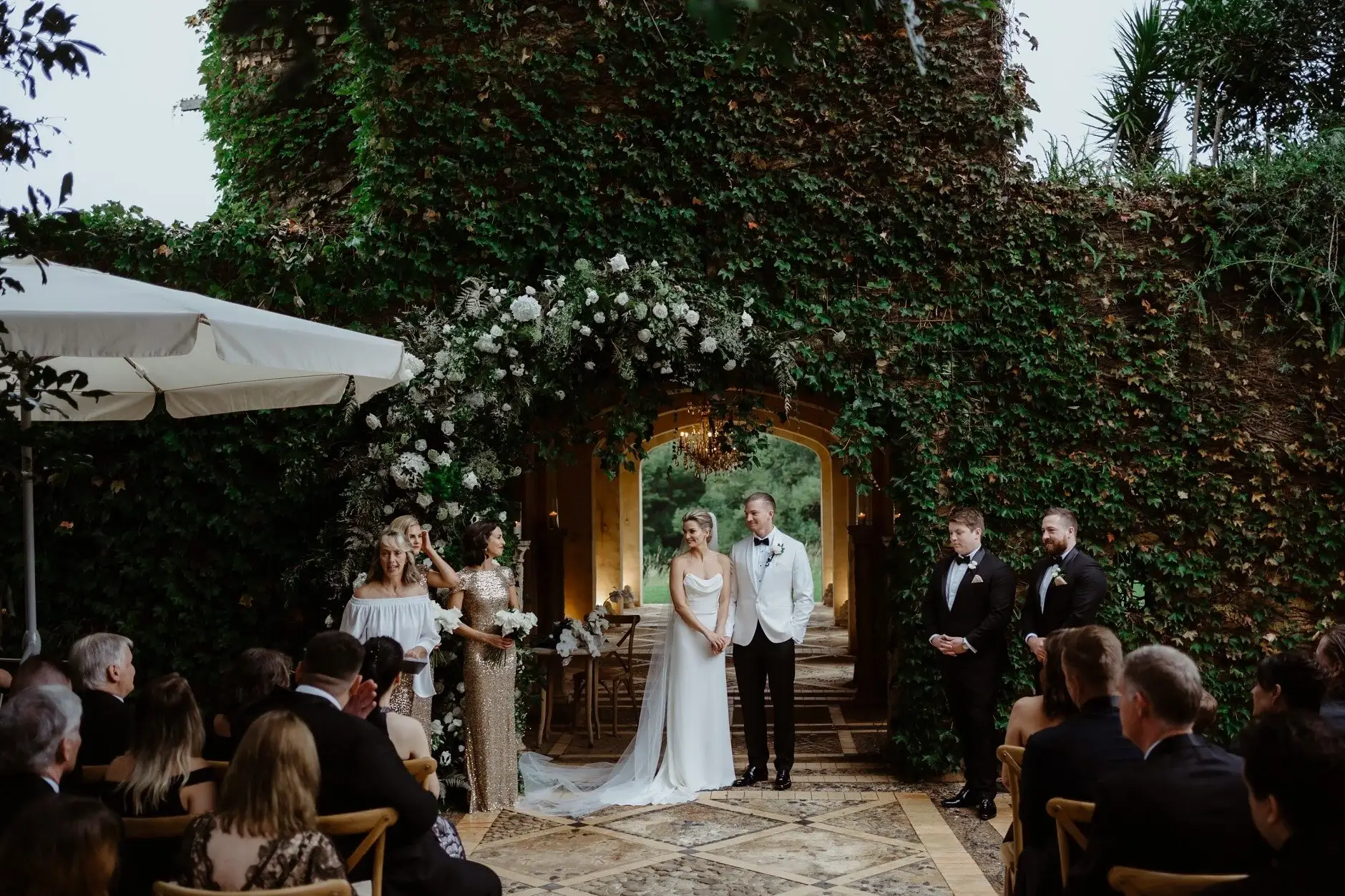 The ceremony beneath the ivy-covered wall at Deux Belettes