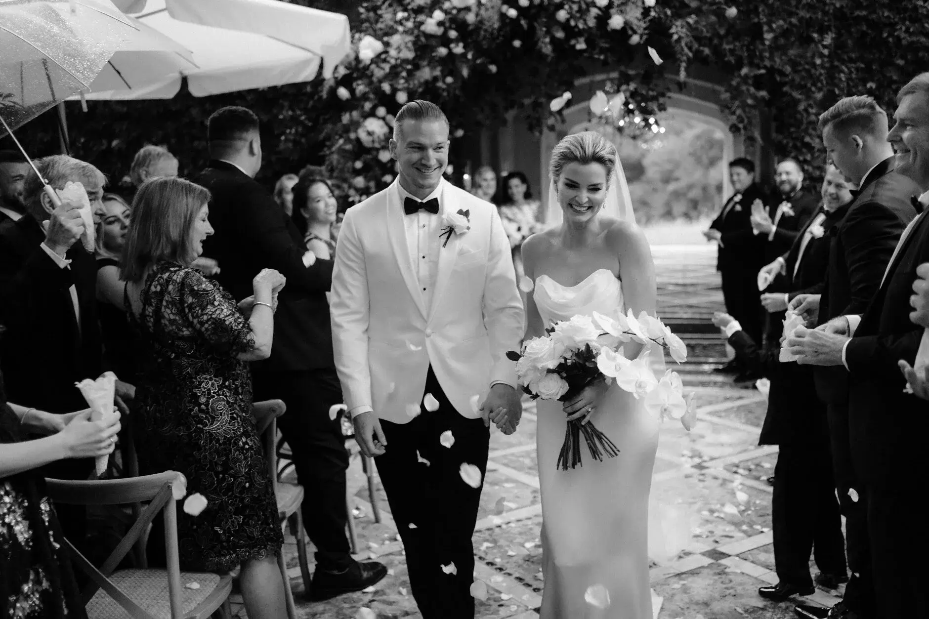 Maddie and John greeting guests with the bouquet in hand, Deux Belettes