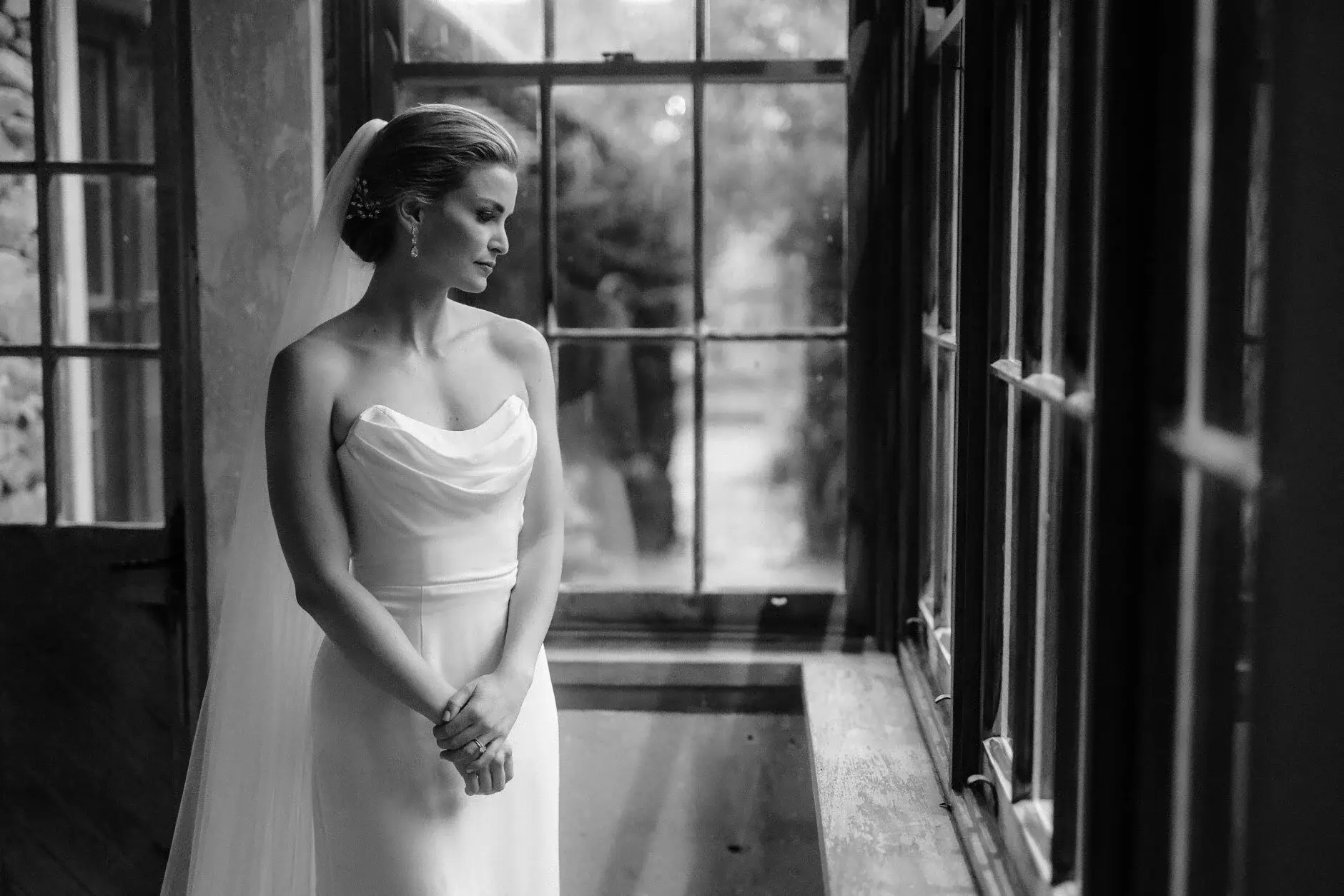 Maddie by the tall farmhouse window in black and white, Deux Belettes