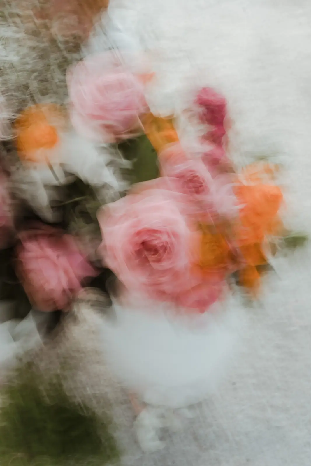 A blur of pink and orange roses in the bouquet, EarthHouse
