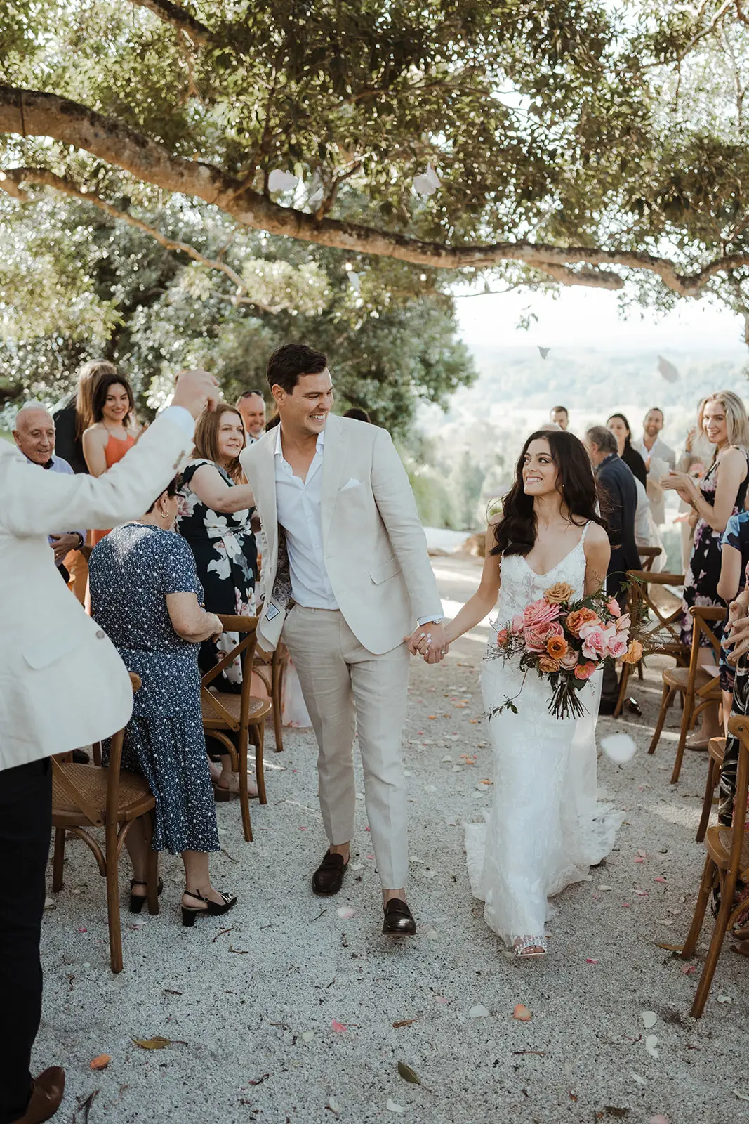 The couple coming back down the gravel aisle after the ceremony, EarthHouse