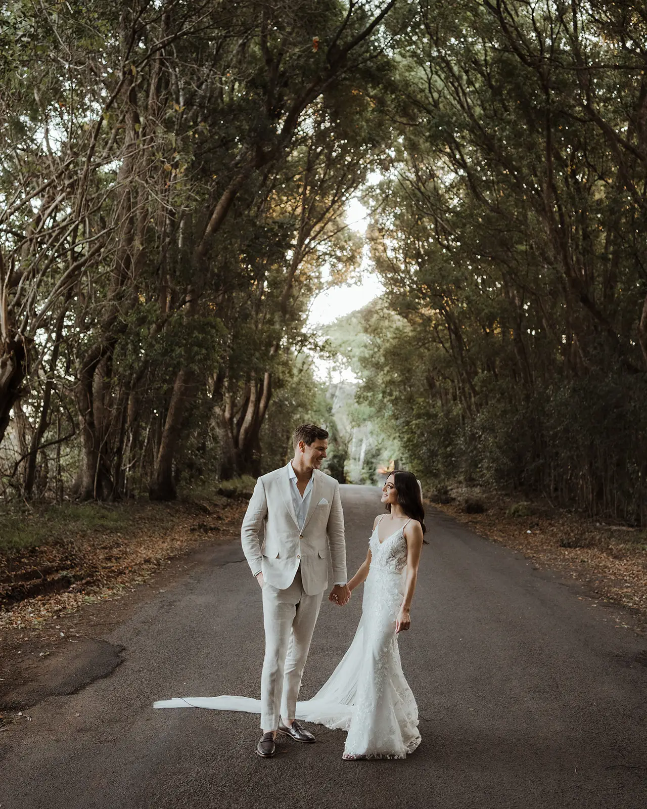 The couple on the tree-lined drive up to the house, EarthHouse