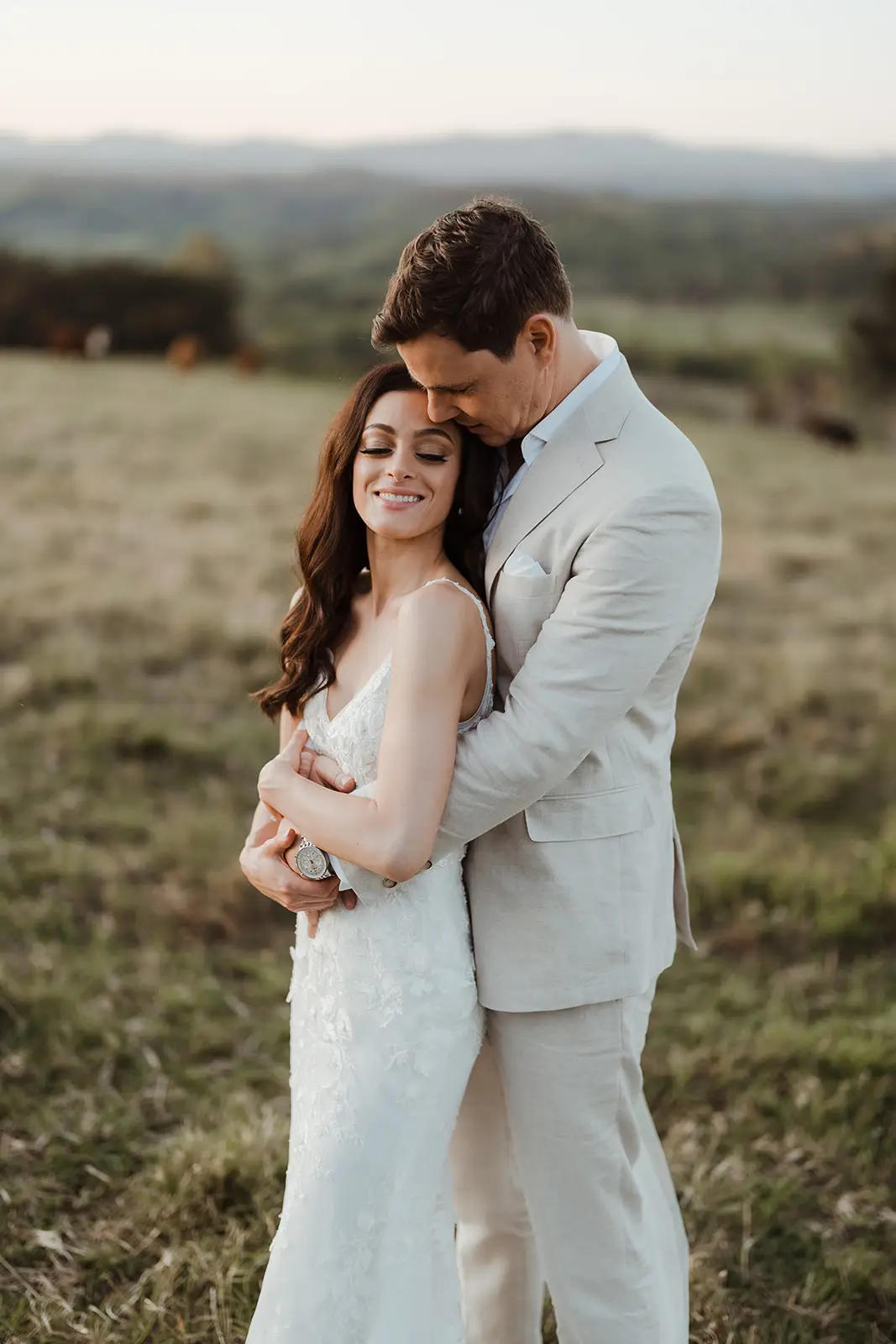The couple in the open paddock with the hinterland ranges behind, EarthHouse