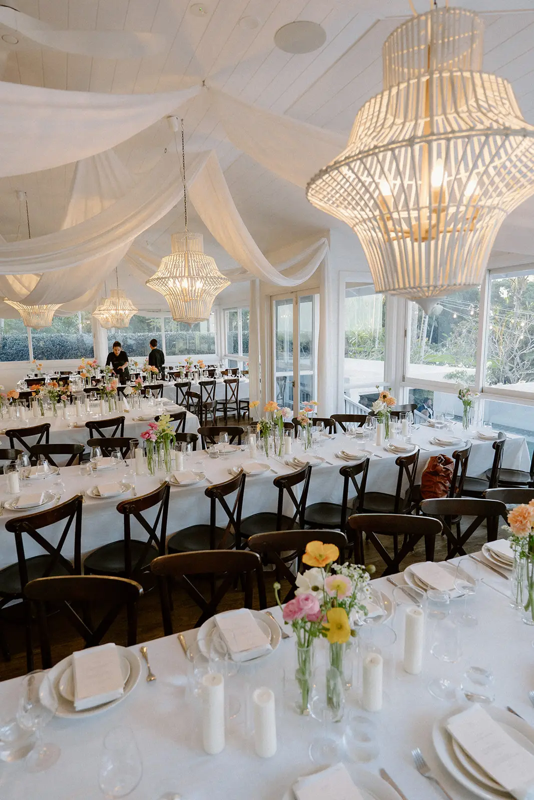 Beaded chandeliers and white draping over the set tables, Fig Tree Restaurant
