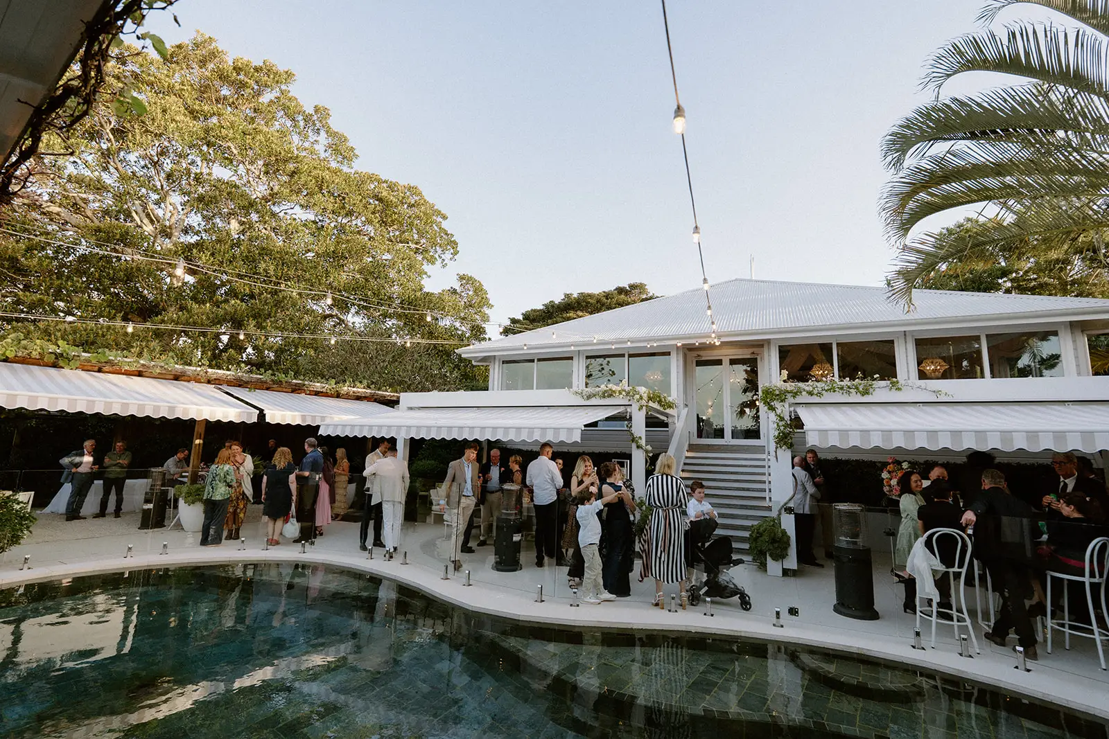 The pool and the terrace bar with the white farmhouse above it, Fig Tree Restaurant