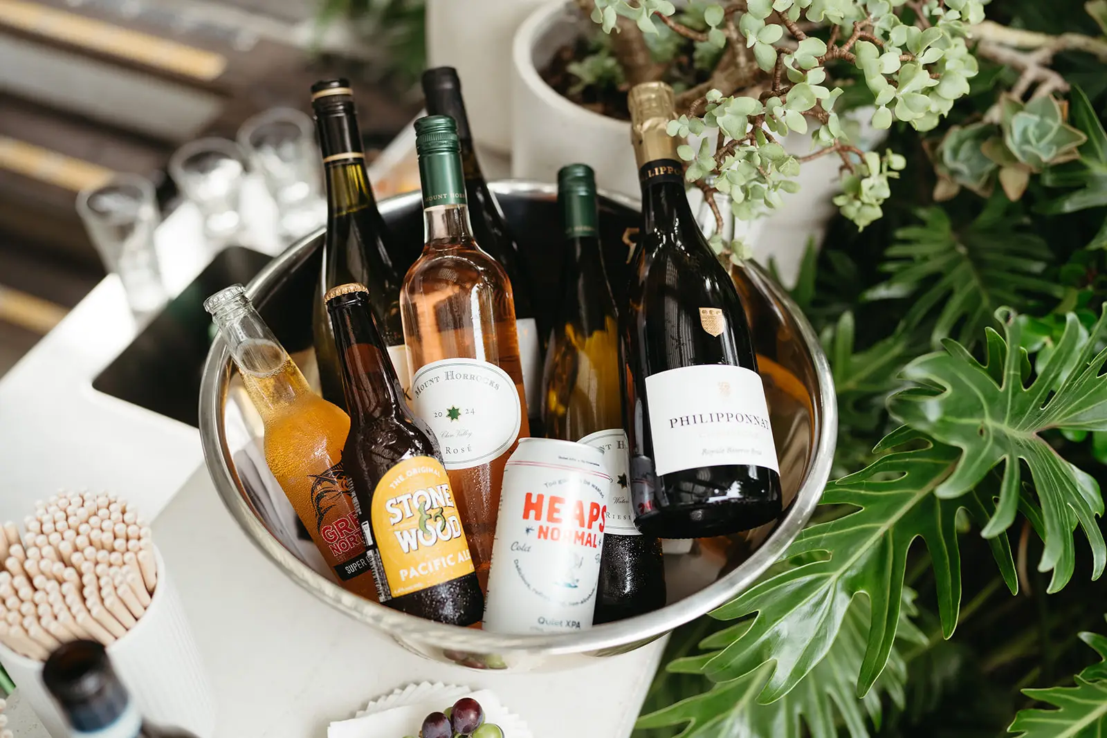 An ice bucket of local wines set among the potted greenery, Fig Tree Restaurant
