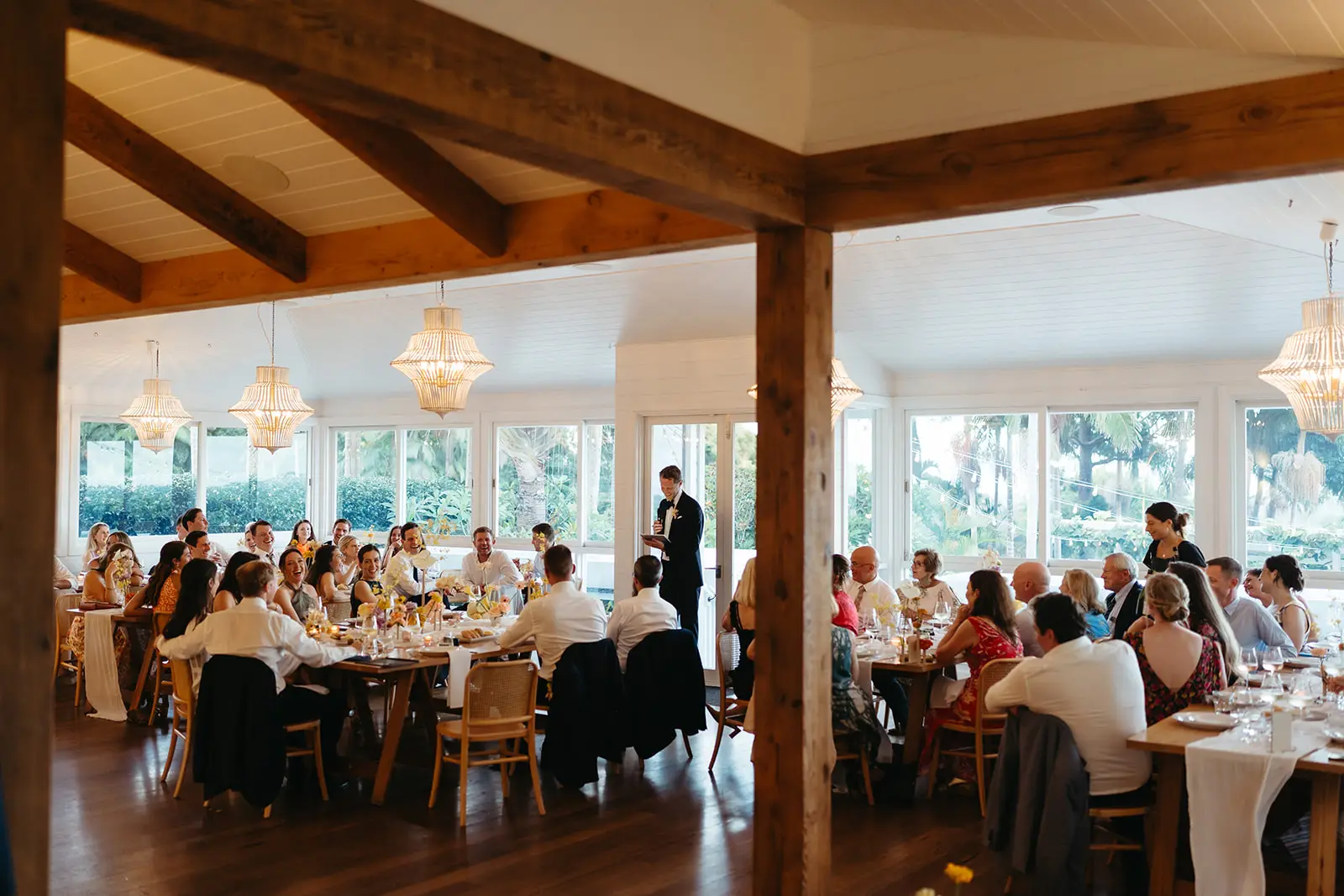 The reception under way at the long tables beneath the timber beams, Fig Tree Restaurant