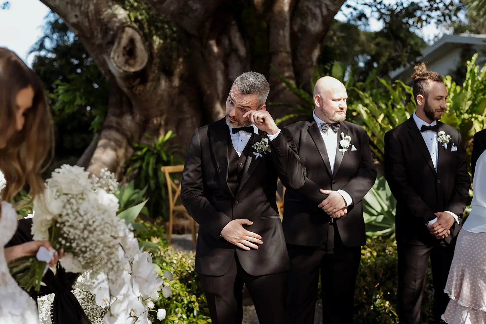 Yoni waiting with his groomsmen beneath the fig trees, Byron Bay