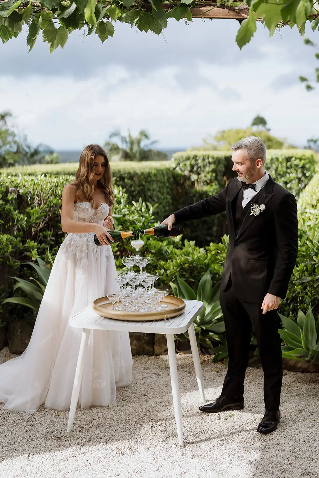 Letitia and Yoni pouring the champagne tower, Fig Tree Restaurant