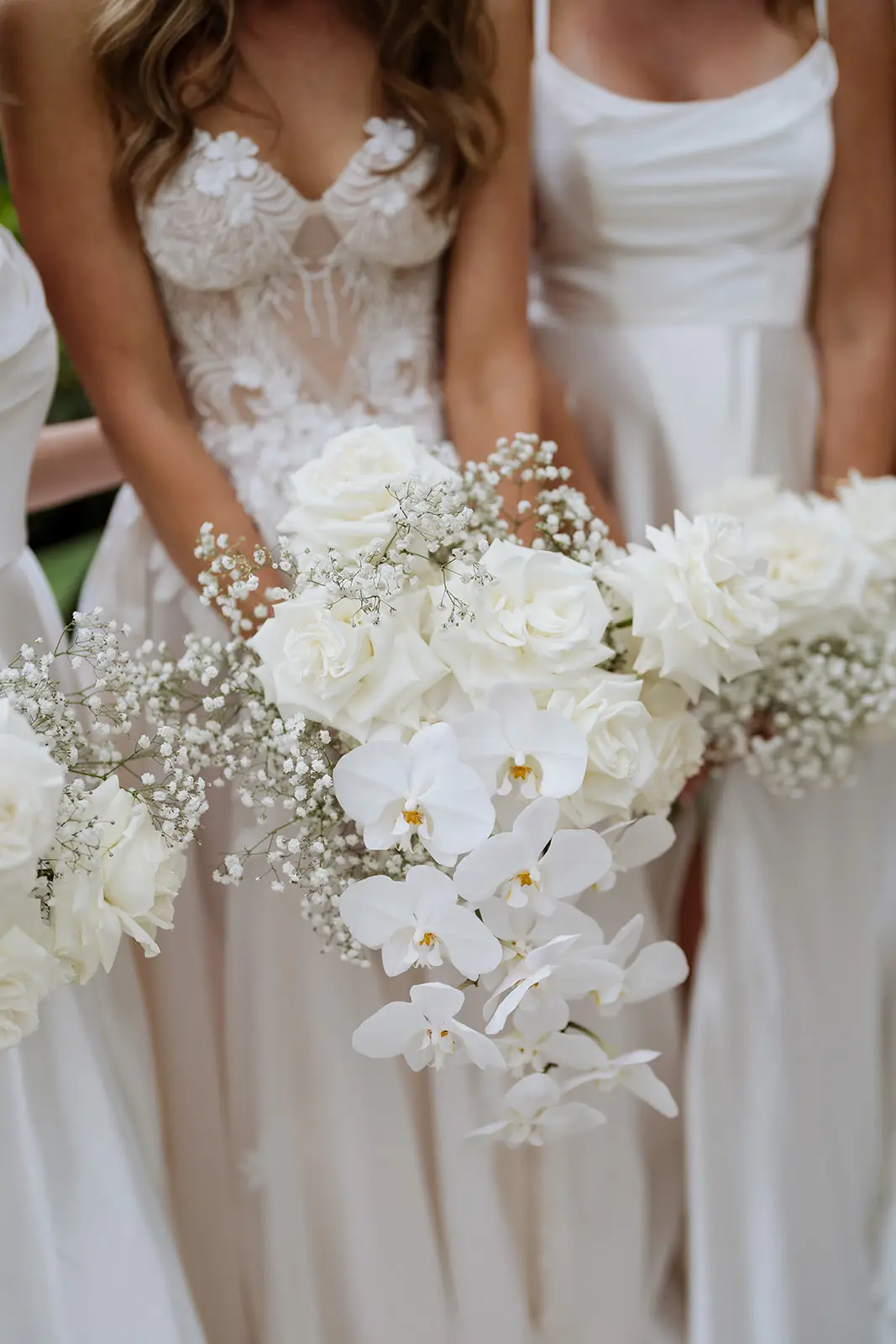 Bridesmaids holding their white bouquets, Fig Tree Restaurant