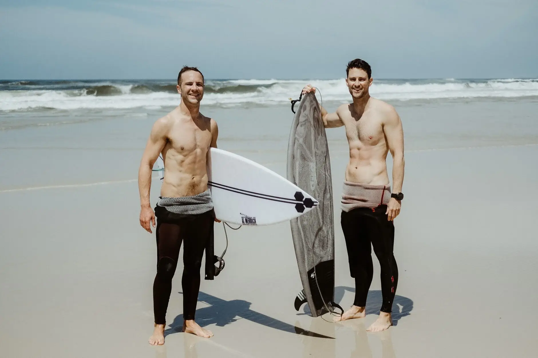 Nev and a mate on the sand at Byron with their surfboards