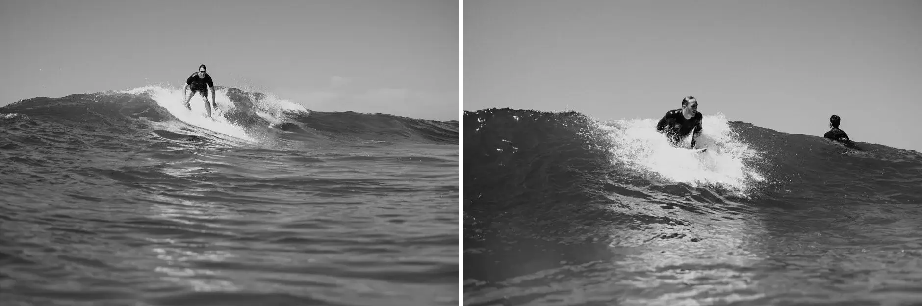 Riding a wave at Byron Bay, black and white