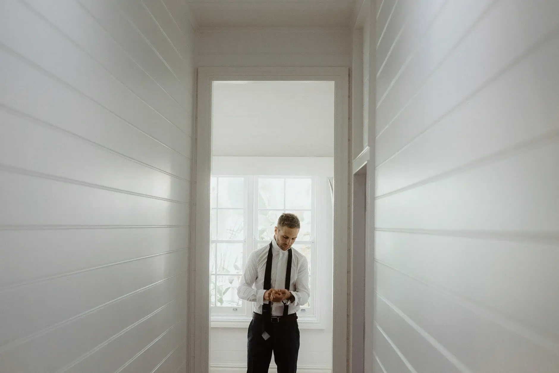 Nev in the hallway with his tie undone, Byron Bay