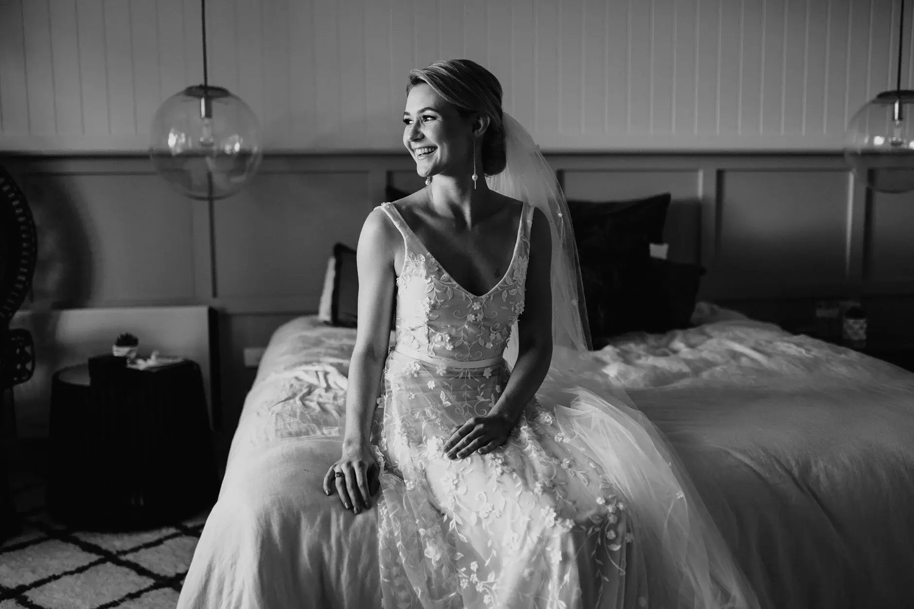 Em sitting on the bed in her gown, black and white, Byron Bay