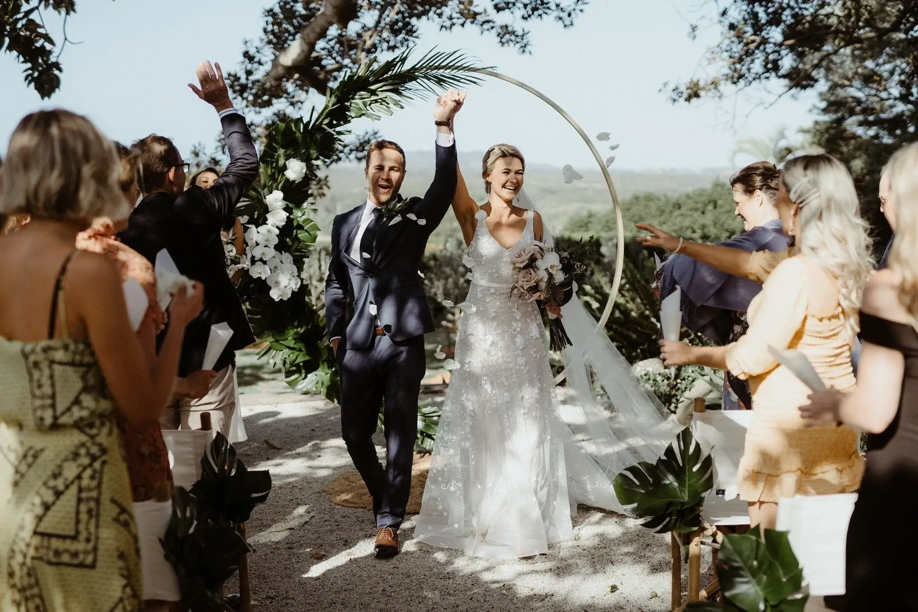 Nev punching the air as they walk back down the aisle, Byron Bay
