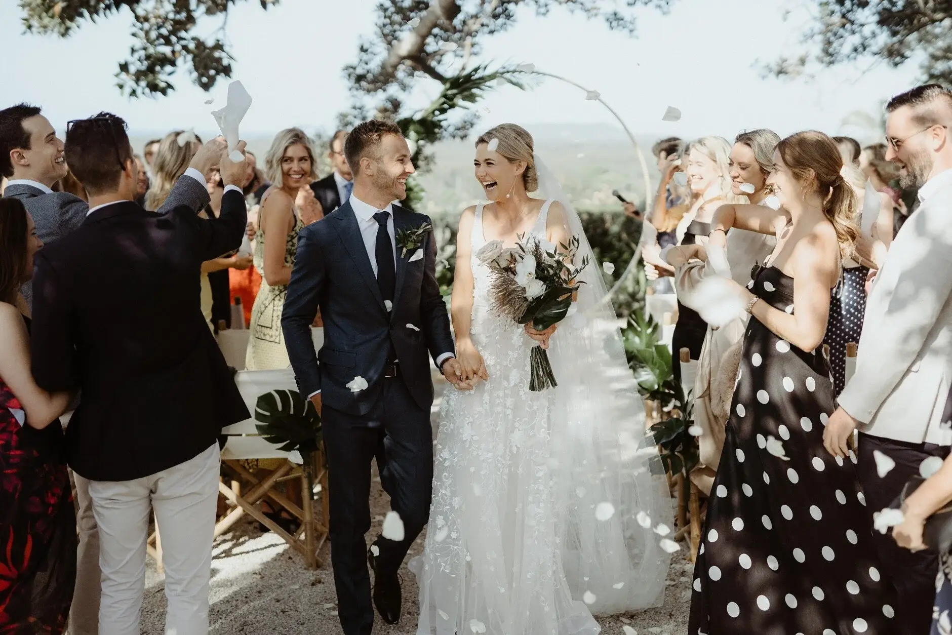 Guests throwing petals as Em and Nev walk out, Byron Bay