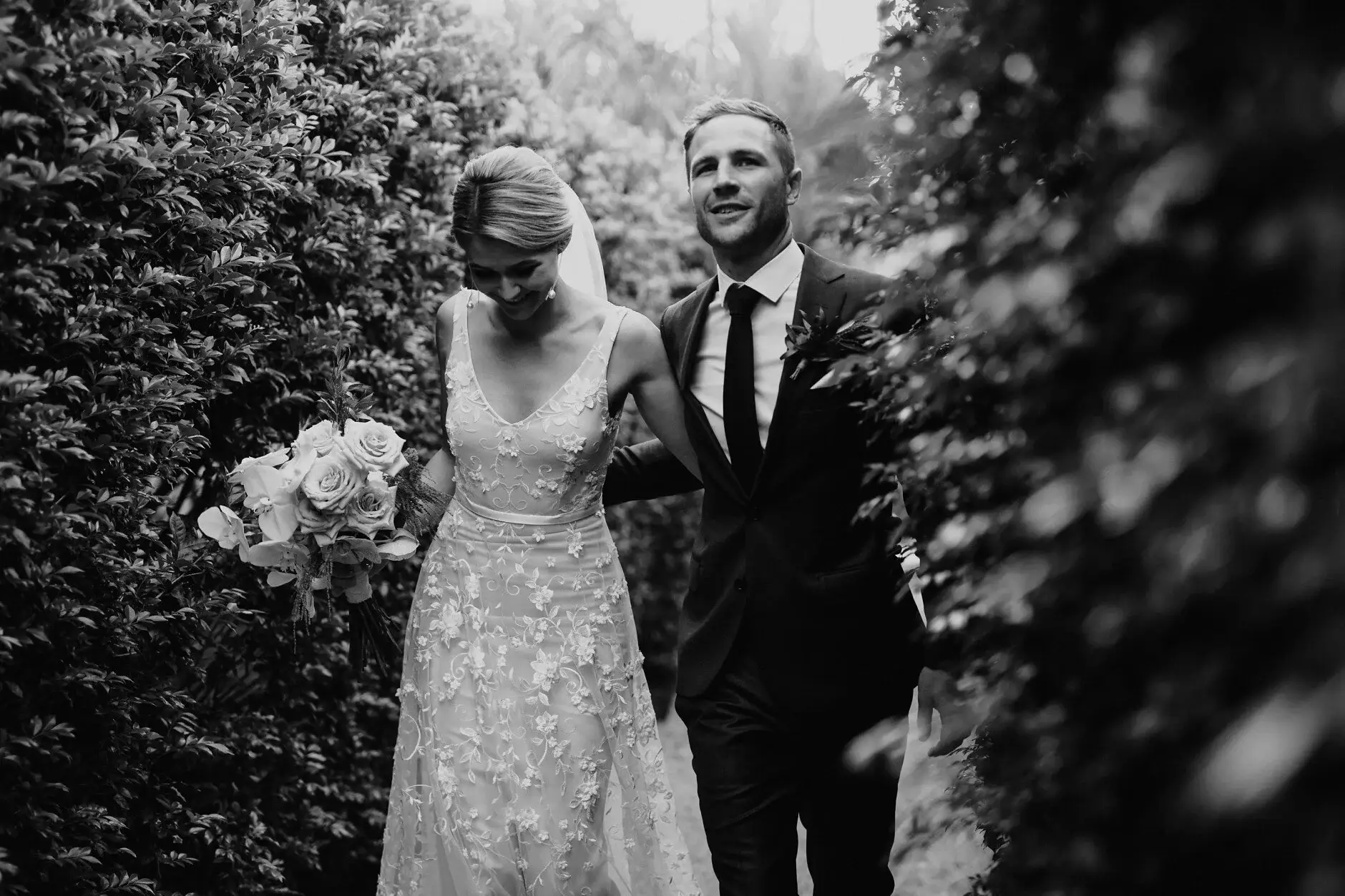 Nev pulling Em in for a kiss beside the hedge, Byron Bay