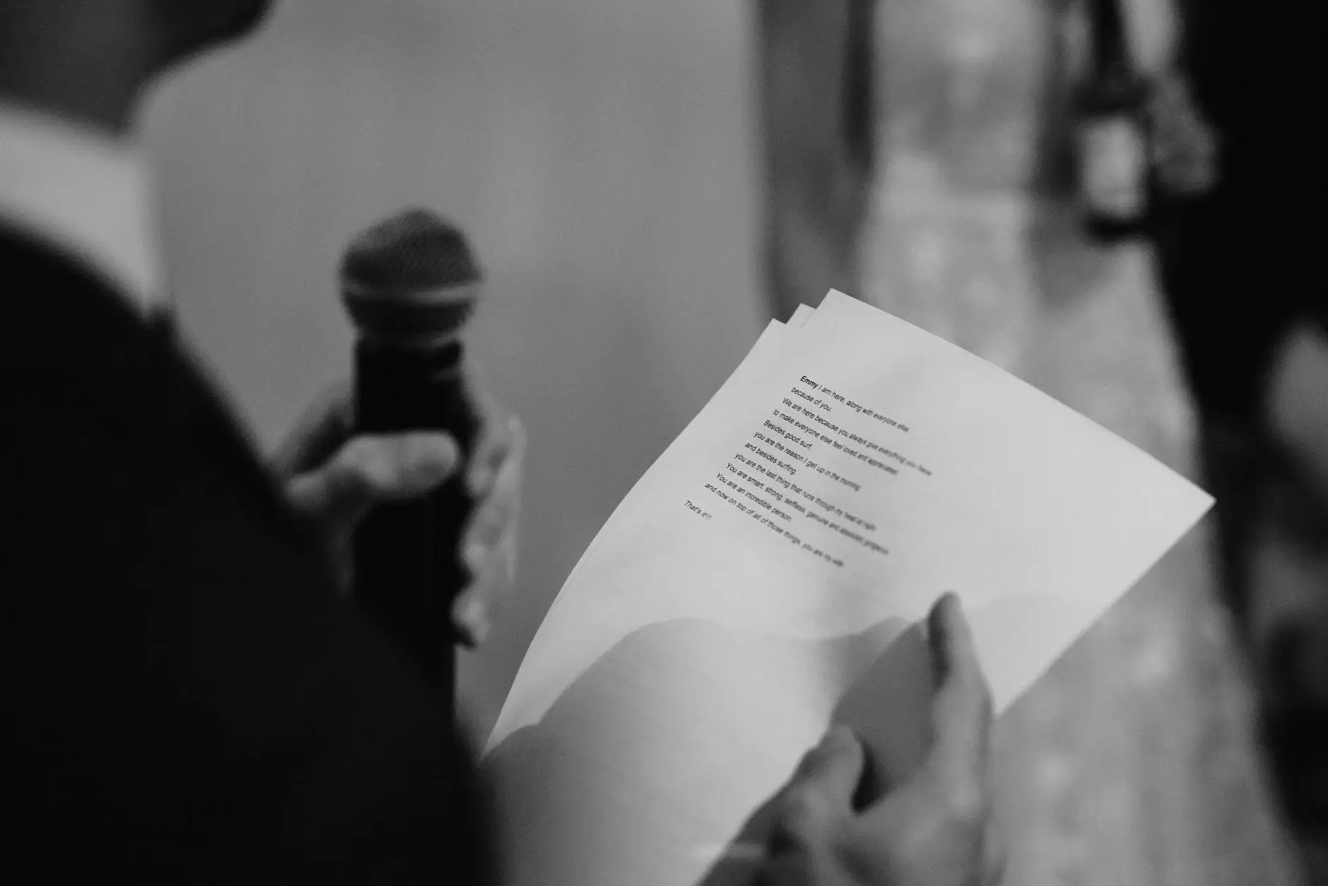 Speech notes held in front of a microphone, black and white