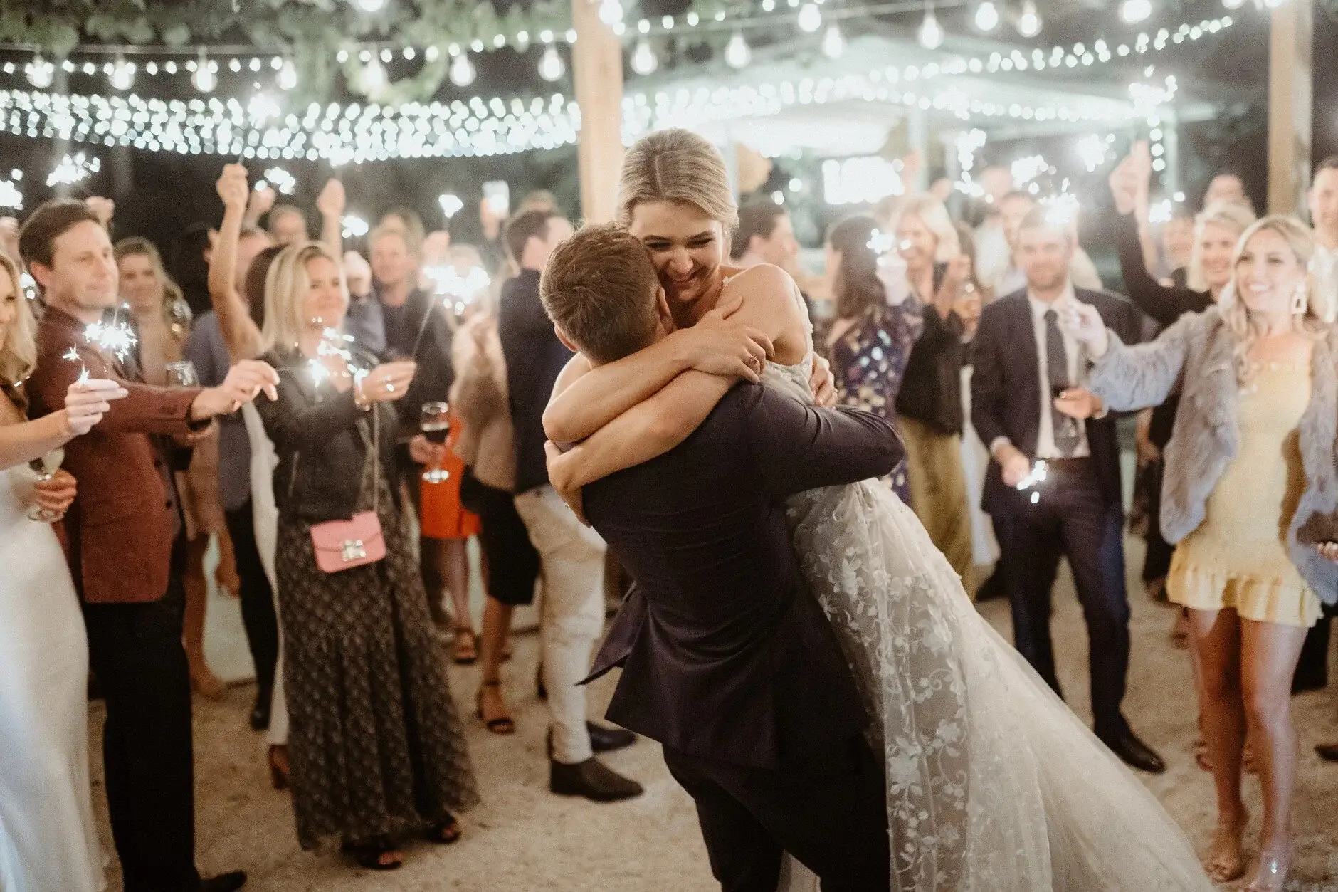Em hugging a guest on the dance floor, Byron Bay