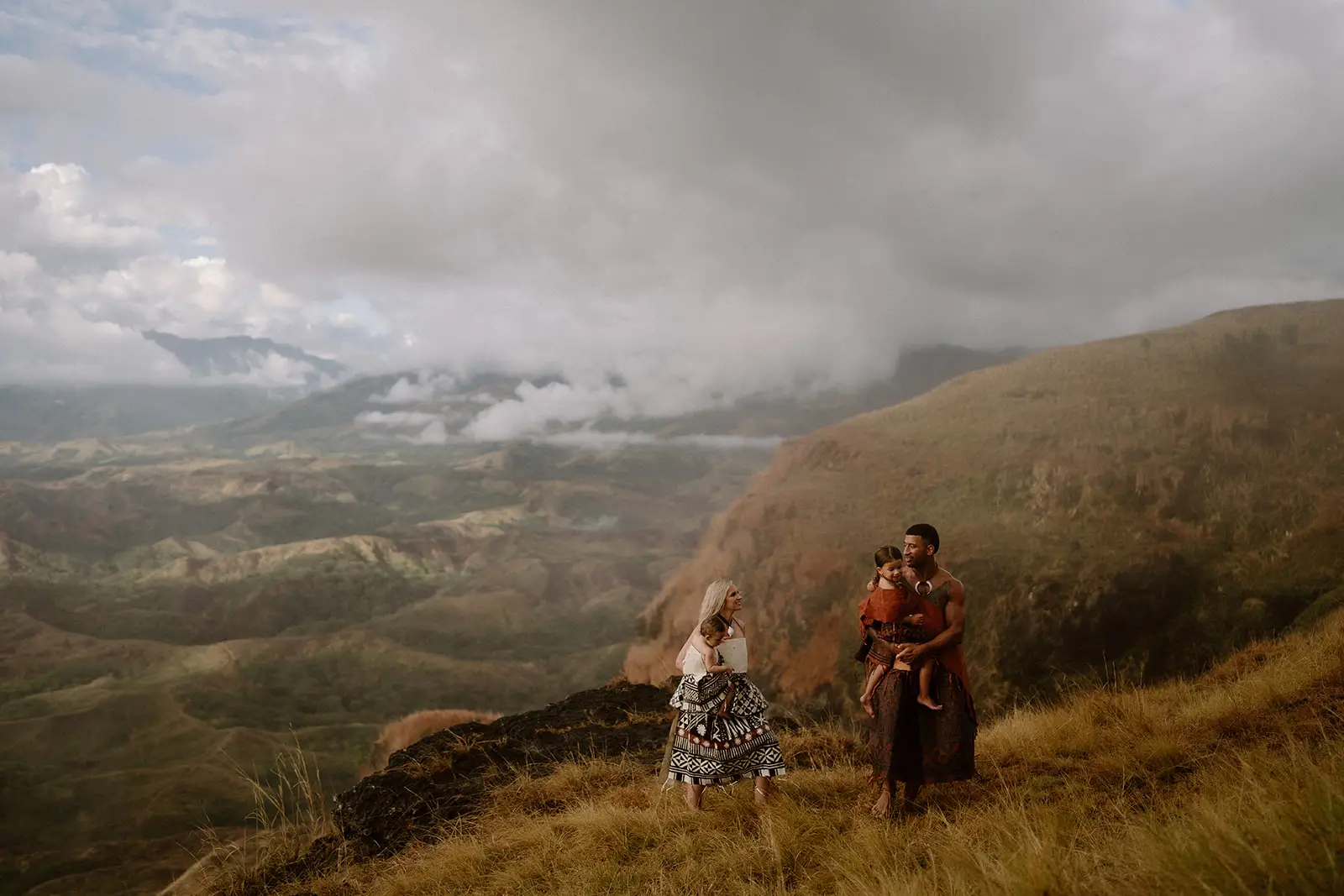 Brittany and Viliame on the ridgeline beneath heavy cloud, Nausori Highlands