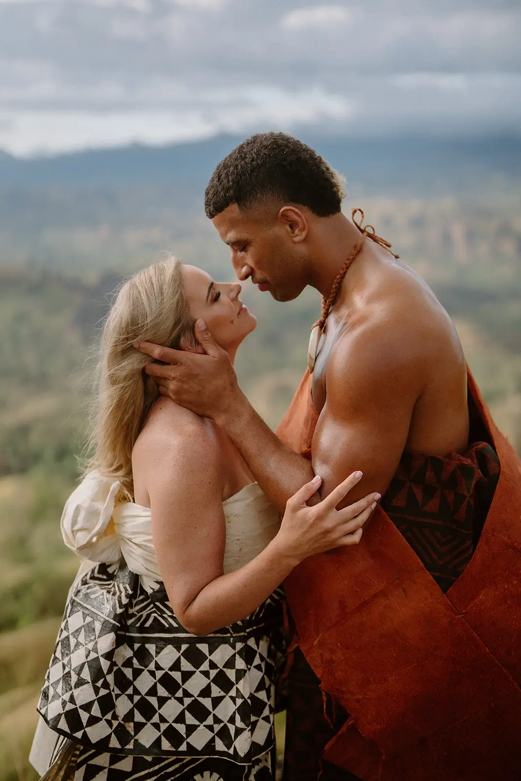 Brittany and Viliame kissing on the ridge in traditional masi, Fiji