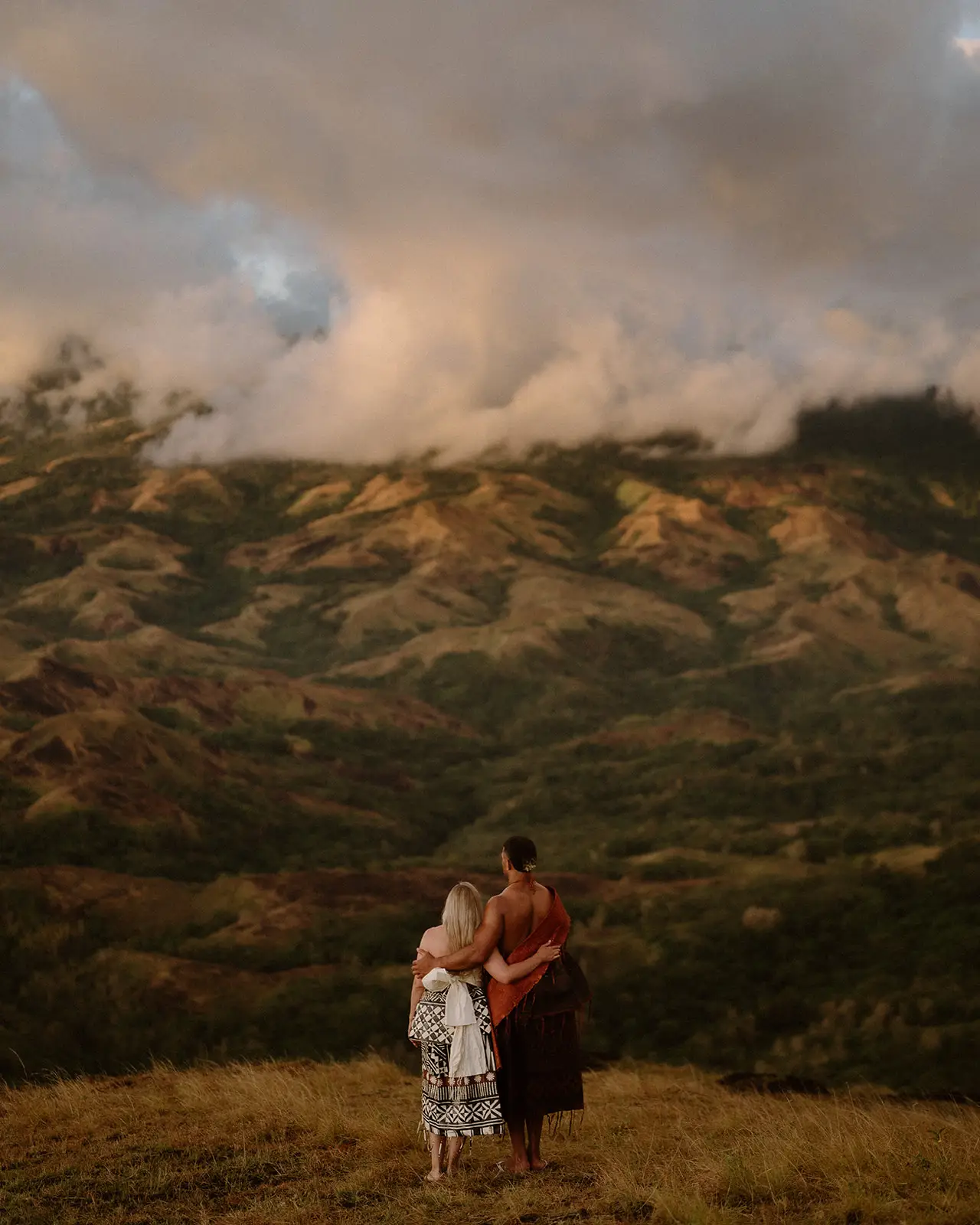 The couple dwarfed by the highland ranges, Fiji