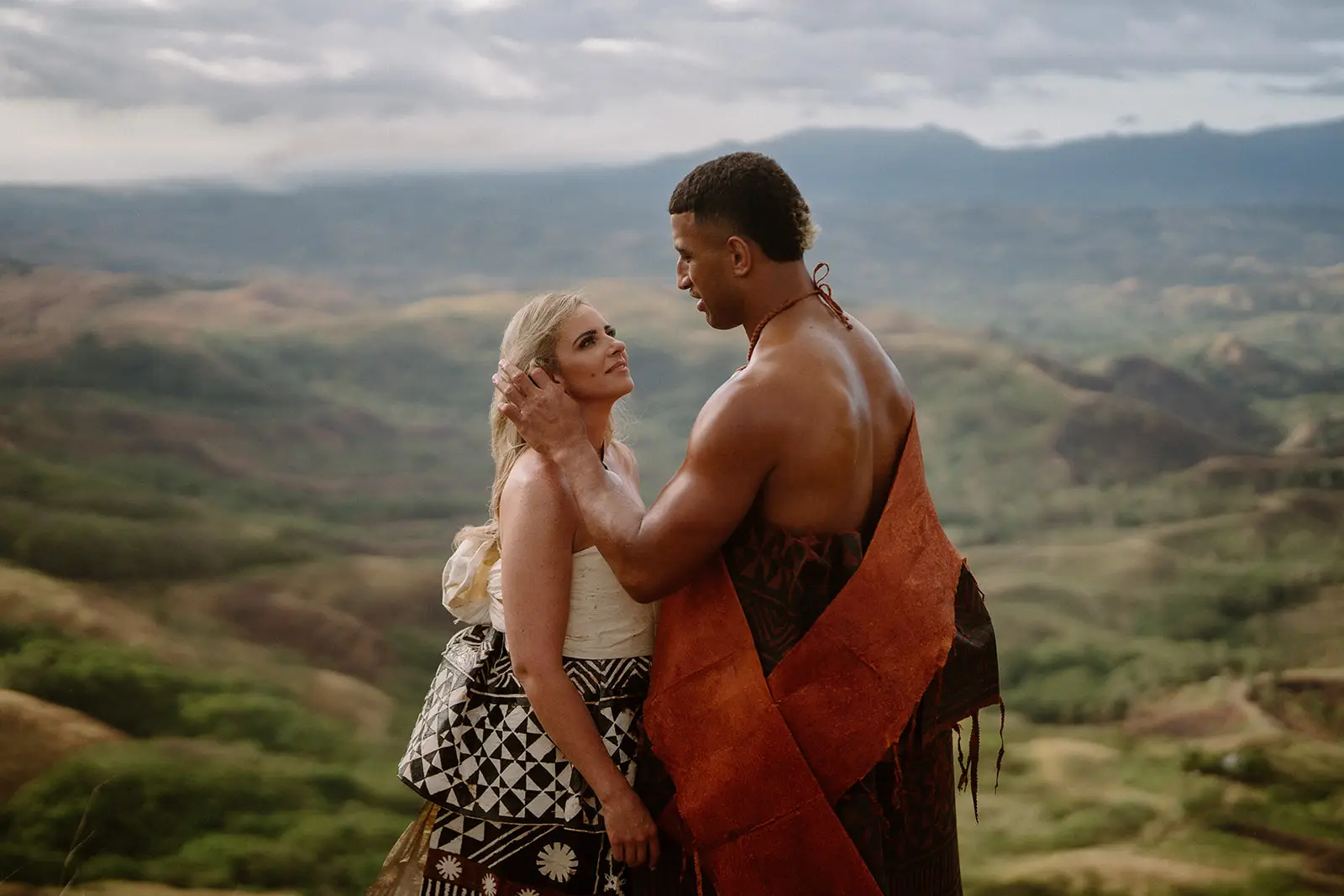 Brittany and Viliame standing in the green highland hills, Fiji