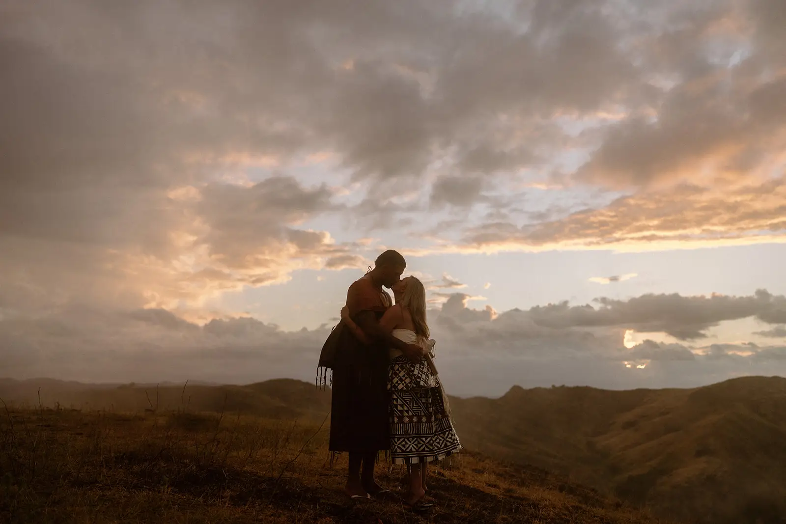 Brittany and Viliame silhouetted at sunset in the highlands, Fiji