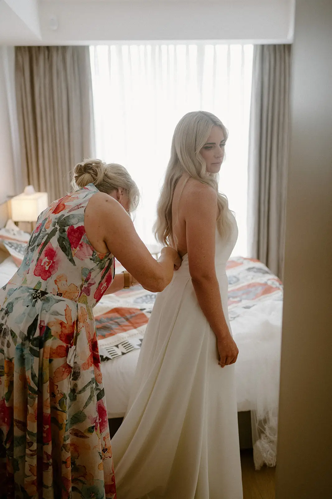 Brittany getting into her dress by the window, Crowne Plaza Nadi Bay