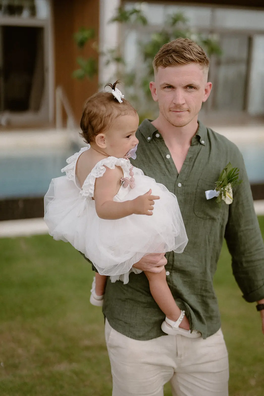 A guest carrying a baby to the ceremony, Nadi Bay