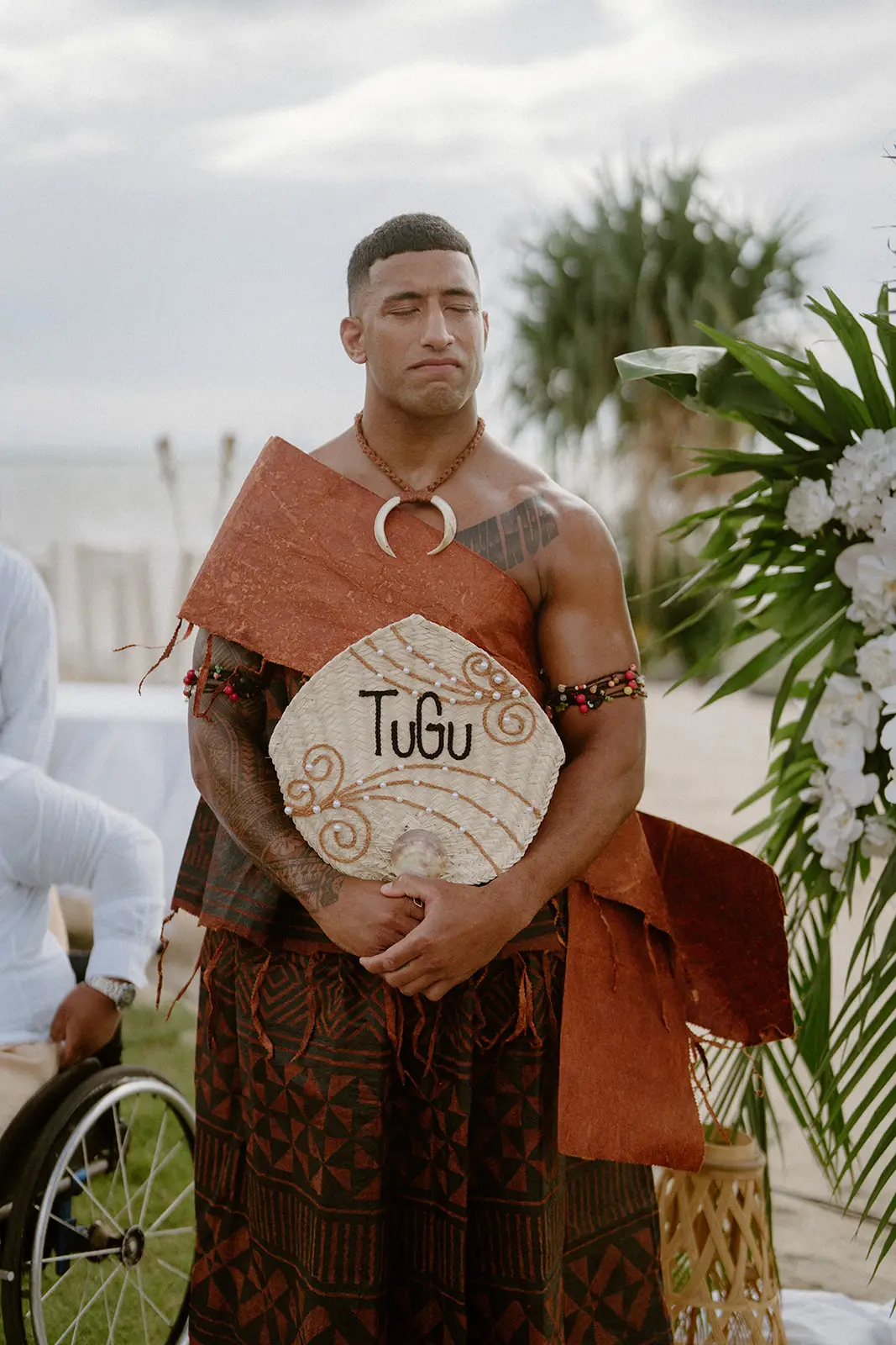 Viliame waiting at the ceremony with a woven fan, Nadi Bay
