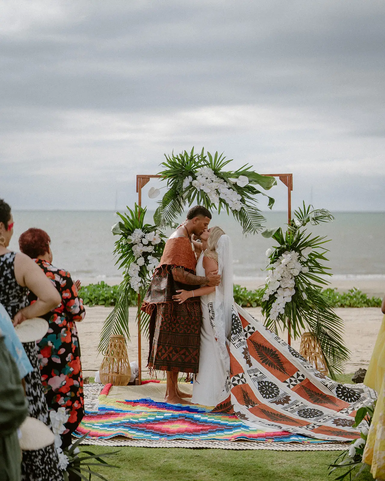 Exchanging vows beneath the floral arch, Crowne Plaza Nadi Bay