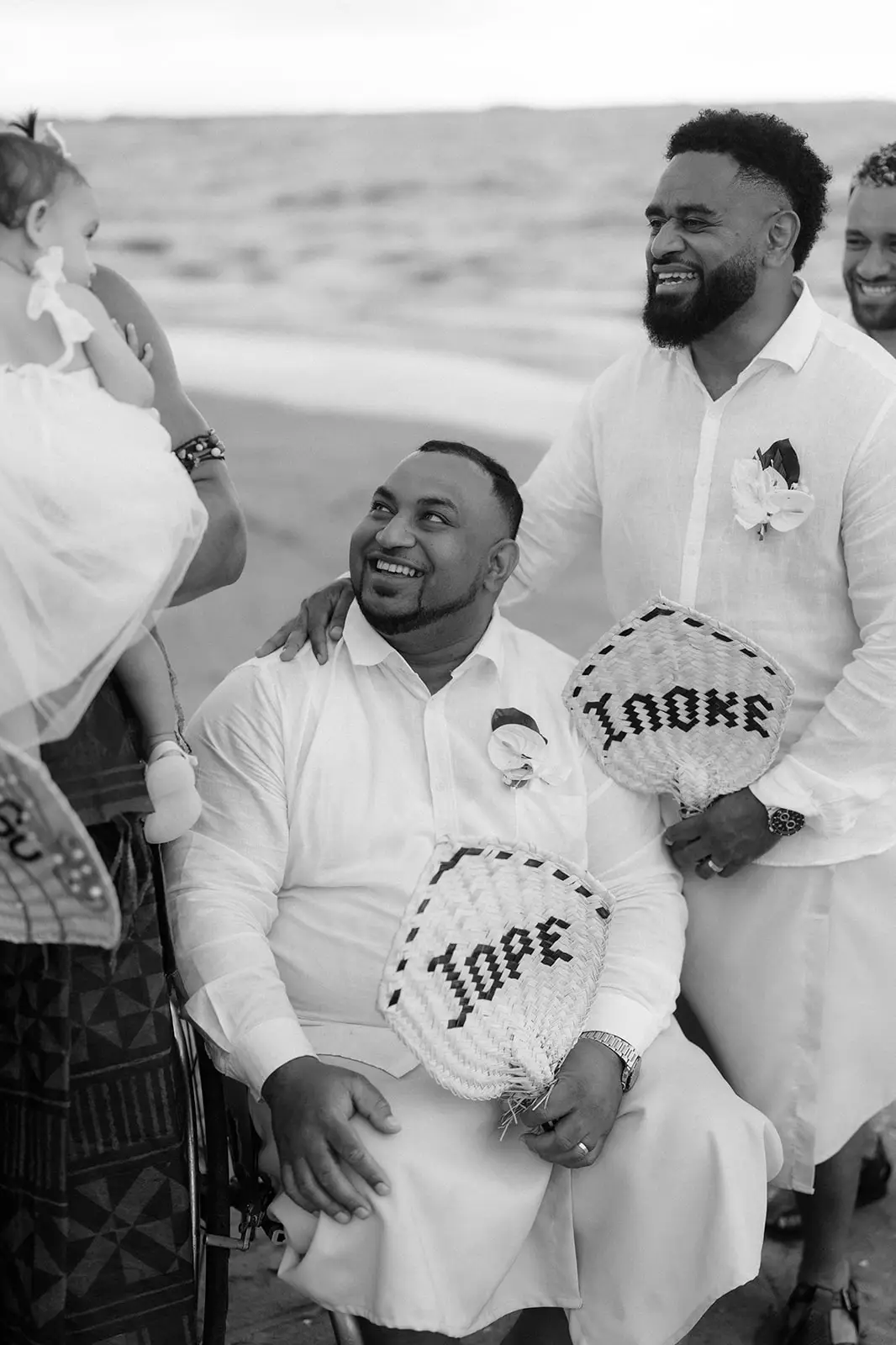 A groomsman laughing with his woven fan, Nadi Bay