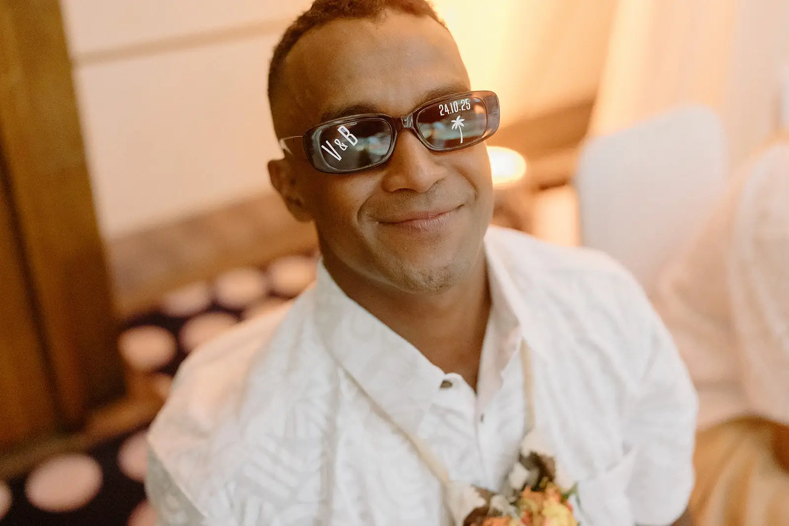 A guest in personalised wedding sunglasses at the reception, Nadi Bay