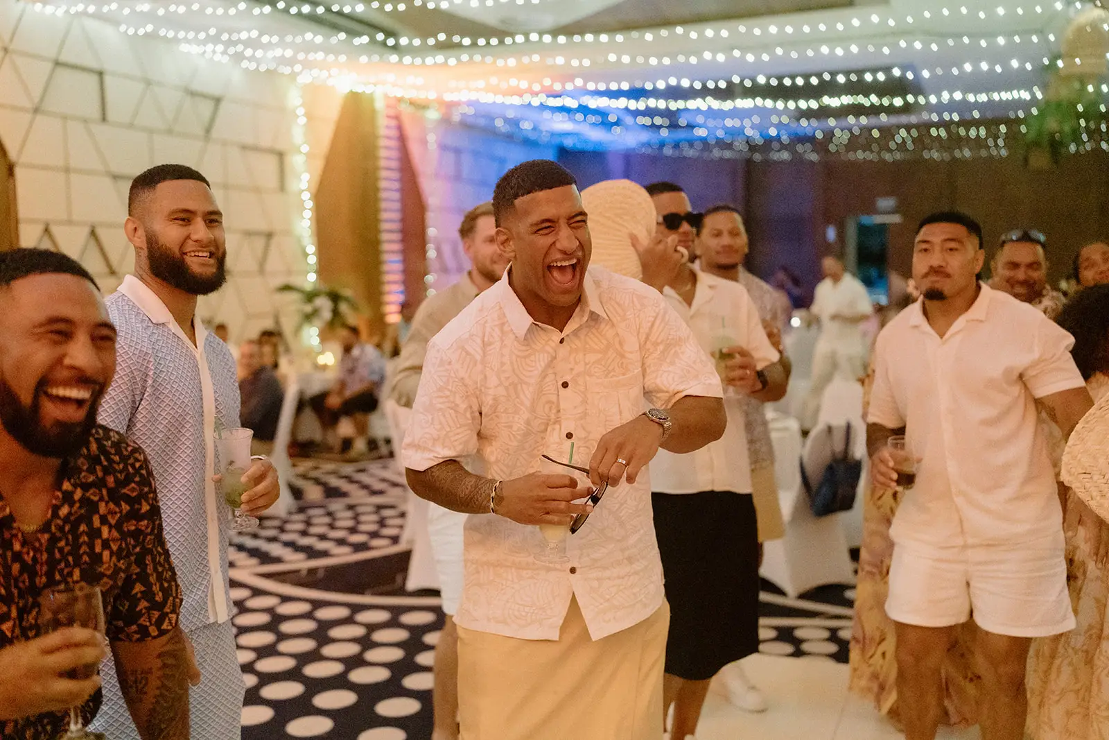 Guests dancing under festoon lights at the reception, Nadi Bay