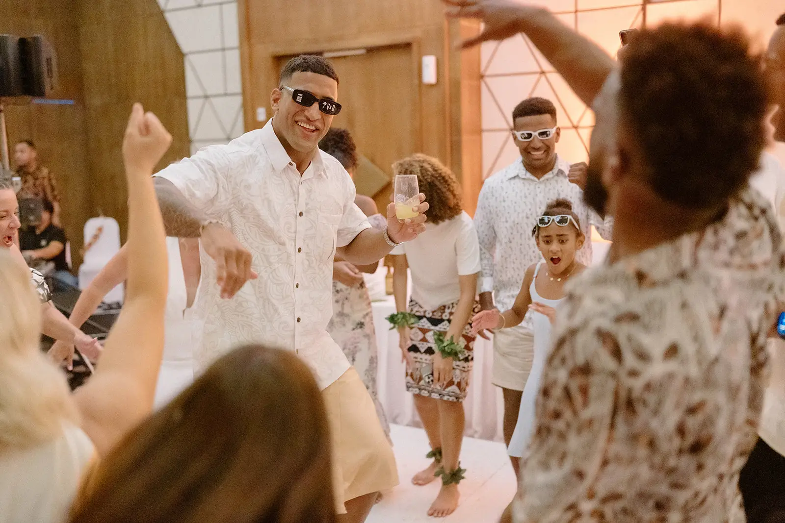 Guests dancing in island shirts at the reception, Nadi Bay