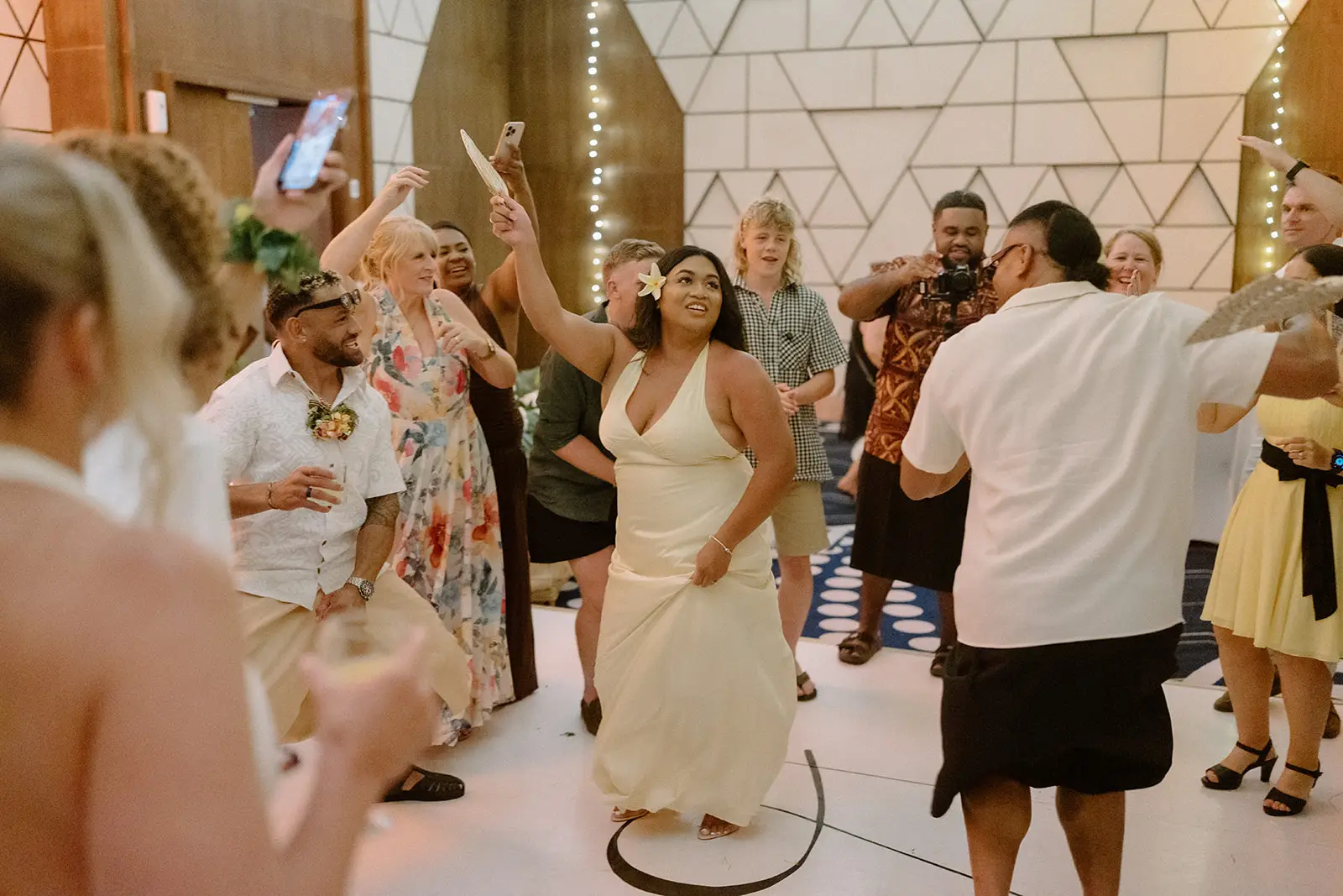 Guests with arms raised on the dance floor, Nadi Bay