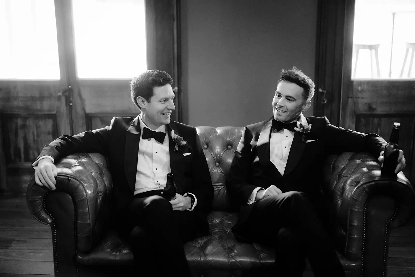 Black and white — two grooms on a Chesterfield in the library, Gabbinbar Homestead