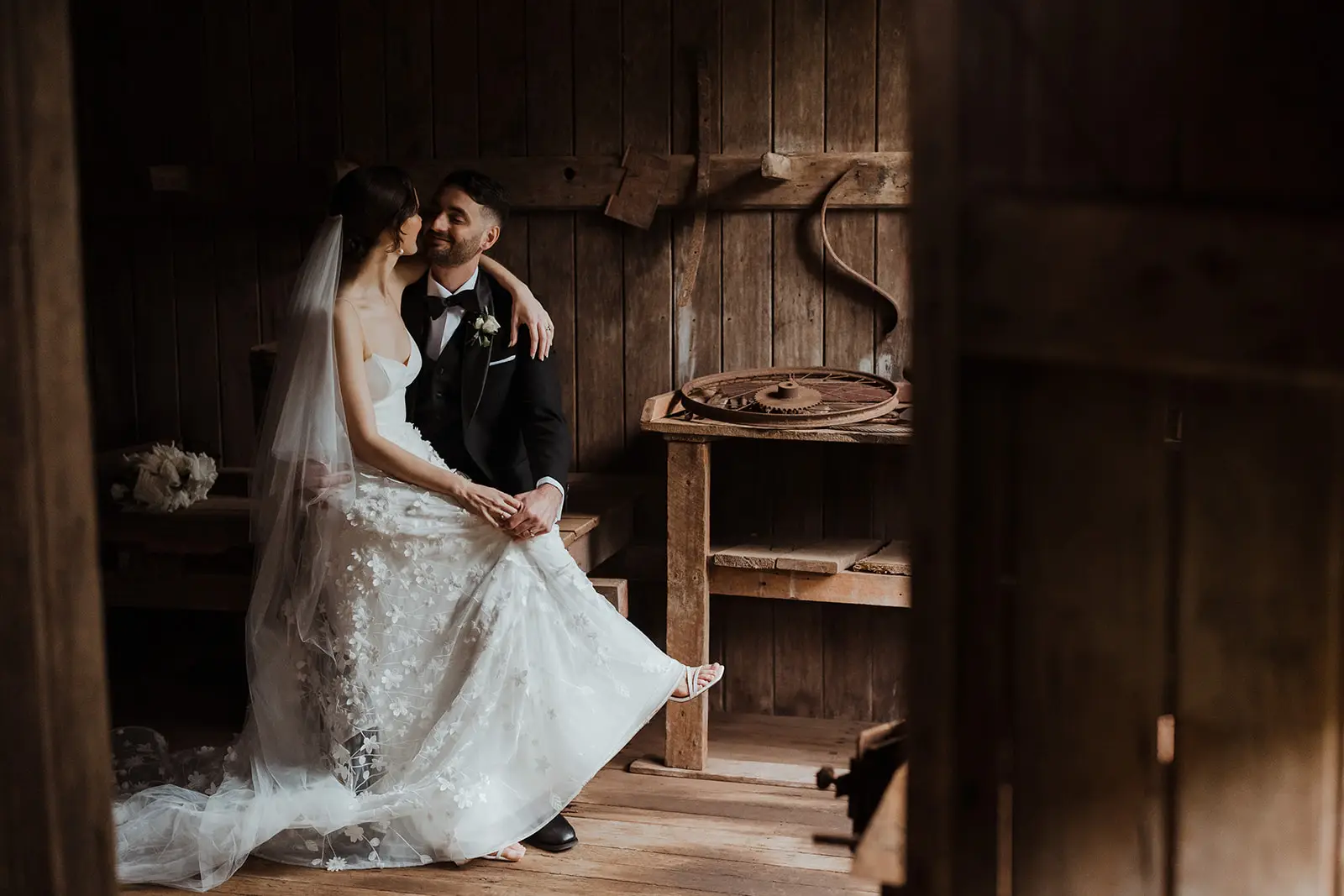 The couple in the old timber workshop, the dress spread across the floor, Gabbinbar Homestead